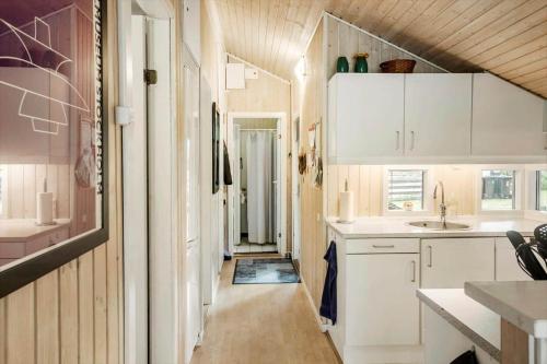 a kitchen with white cabinets and a sink at M396-Vaeggerlose-Torilisvej-3 in Bøtø By
