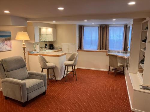 a kitchen with chairs and a table and a counter at Briarwood Inn in Carmel