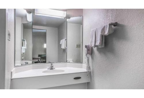 a bathroom with a sink and a large mirror at Motel 6-Monroe, LA in Monroe