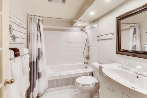 a white bathroom with a toilet and a sink at Quiet Studio near Glen Park in San Francisco