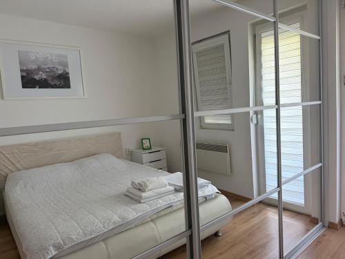 a bedroom with a bed and a glass wall at Crystal Lux in Veles