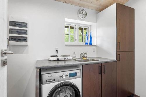 a kitchen with a washing machine and a sink at L40-Rodby-Glentevej-11 in Rødby
