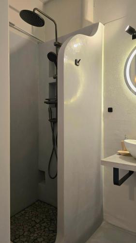 a bathroom with a shower and a sink at Teos Sunset View Apartment in Batsi