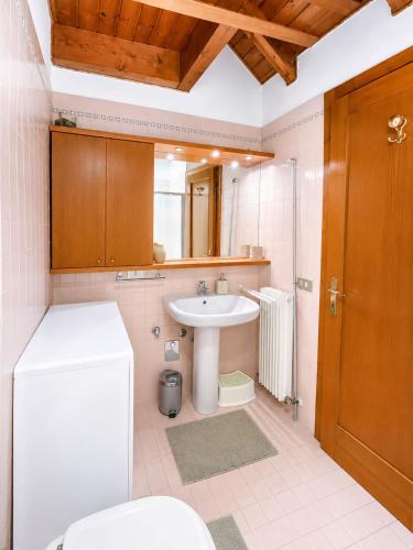 a bathroom with a sink and a toilet at Appartamento Belvedere in Asiago