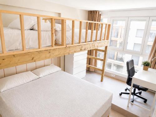 a bedroom with a bunk bed and a desk at Beach Apartment in Torre del Mar in Torre del Mar