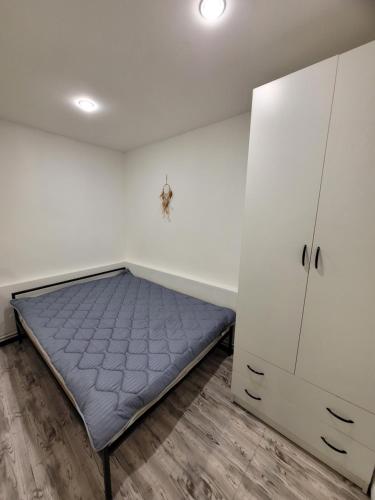 a bedroom with a bed and a cabinet at Дом 33 возле клиники Астхик in Yerevan