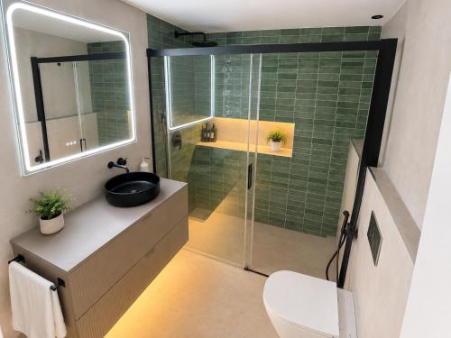 a bathroom with a shower and a sink and a toilet at Beach Apartment in Torre del Mar in Torre del Mar