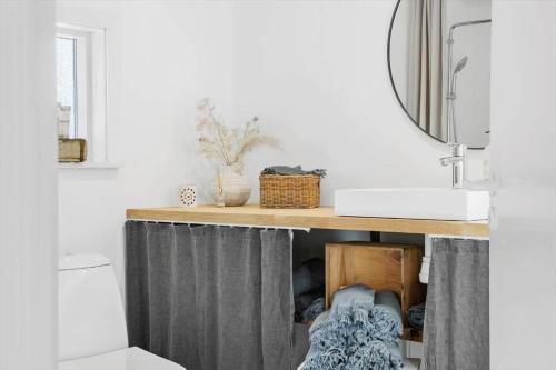 a bathroom with a sink and a vanity with a shower curtain at 30192-Malling-Askvaenget-13 in Malling