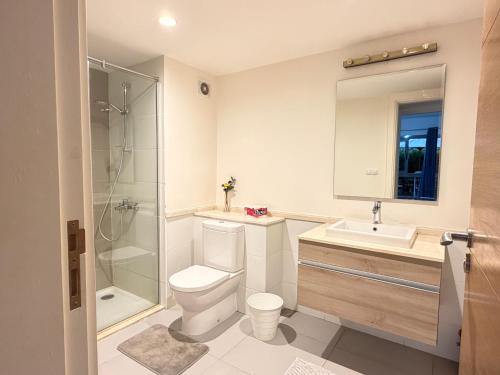 a bathroom with a toilet and a sink and a shower at Condo in Marassi Marina in El Alamein