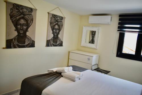 a bedroom with a bed with towels on it at Calliroe Sea View in Alexandroupoli