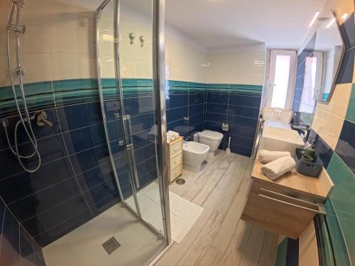 a bathroom with a shower and a toilet and a sink at La casa di venera in Bacoli
