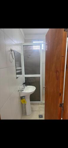 a bathroom with a white sink and a mirror at Acordes de Gaitas - Departamento 2 in Malargüe