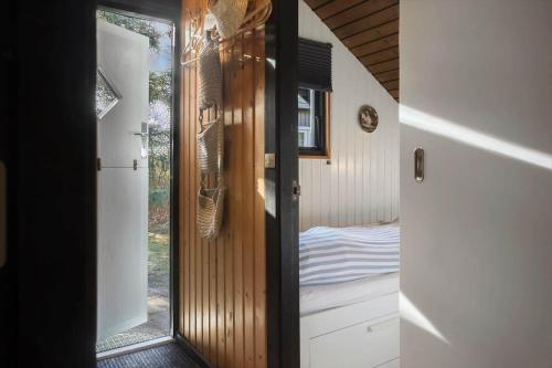 a room with a door with a mirror and a bed at M404-Gedser-Frede-Buchsvej-3 in Gedser