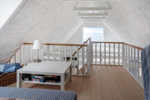 a room with a staircase with a table and a bed at M411-Gedser-Sdr-Boulevard-6-B in Gedser
