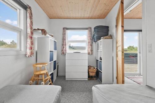 a bedroom with two beds and two windows at C11241-Hemmet-Ildervej-22 in Hemmet