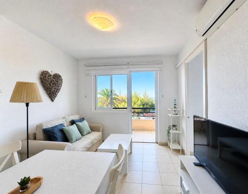 a living room with a couch and a tv at Casa Sol de Jandía in Morro del Jable