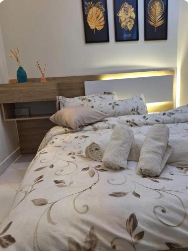 a bedroom with a bed with pillows on it at إقامة مريحة وممتعة في شارع الاميرات in Baghdād