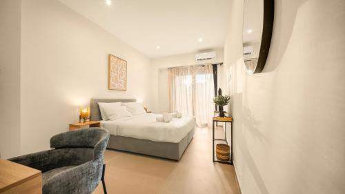 a bedroom with a bed and a chair at Ormos Piraeus in Piraeus