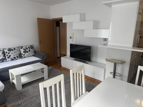 a living room with a couch and a tv at Golden Lux in Berane