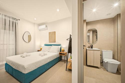 a bedroom with a bed and a bathroom at Ormos Piraeus in Piraeus