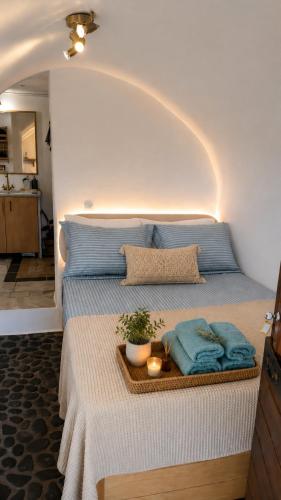 a bed with a tray with towels on it at MonemBlue in Monemvasia