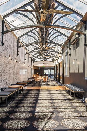 a hallway with benches and tables in a building at Berri Hotel in Berri