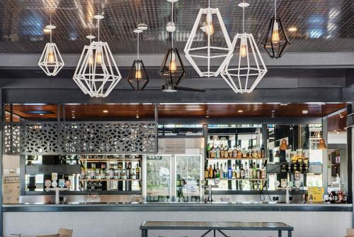 a bar with several lights hanging from the ceiling at Berri Hotel in Berri