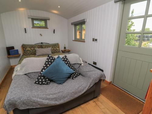 a bedroom with a bed with pillows and a door at Bramleys in Taunton