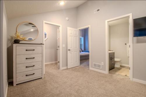 a bedroom with a white dresser and a mirror at CrossLake Getaway in Cross Lake