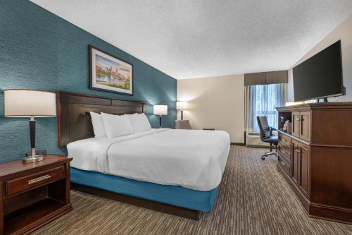 a hotel room with a bed and a television at Best Western Plus Indianapolis in Indianapolis
