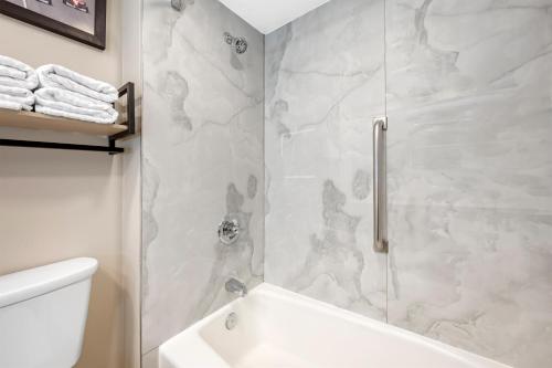 a bathroom with a shower and a toilet and a sink at Best Western Plus Indianapolis in Indianapolis