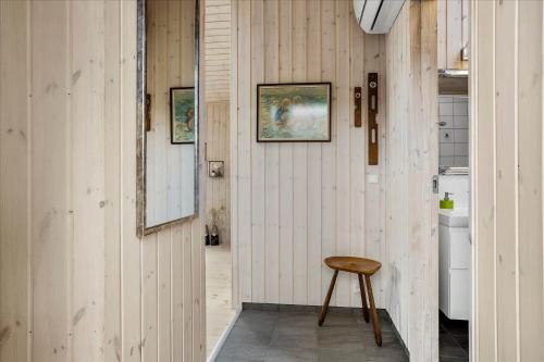 a wooden hallway with a stool and a mirror at 30042-Malling-Peter-Eriksens-Vej-20 in Malling