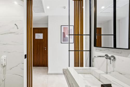 a bathroom with a sink and a mirror at DOM Boutique Hotel in Heraklio