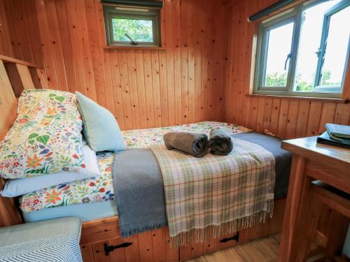 a bedroom with a bed with two shoes on it at Pippins in Taunton