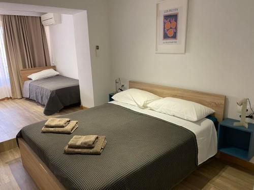 a bedroom with two beds with towels on them at Apartment Sinčić in Novigrad Istria