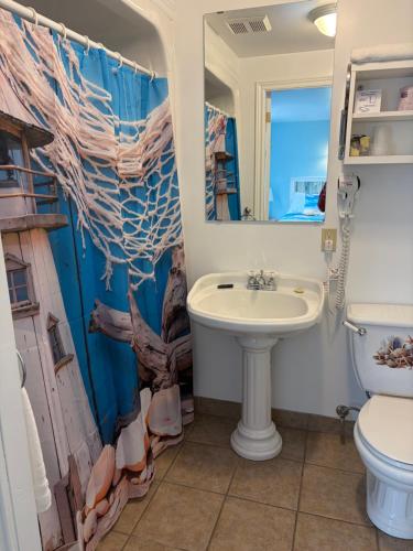 a bathroom with a sink and a toilet at Shoreline Suites in Digby