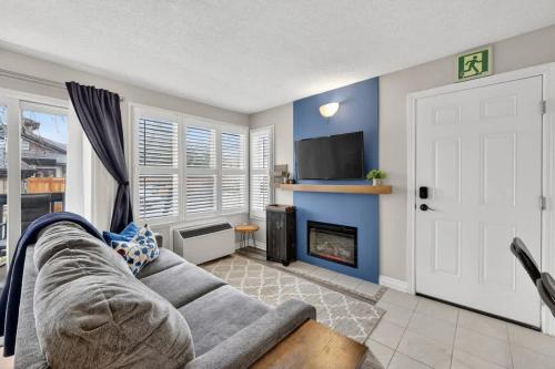 a living room with a couch and a fireplace at Blue Cave Escape - Pool Hot Tub & Shuttle in Blue Mountains