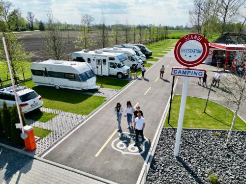 a rendering of a parking lot with a group of rvs at SCANDINAVIA Camping in Zator