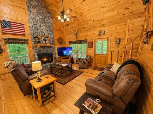 a living room with a couch and a fireplace in a cabin at Lords View in Mineral Bluff