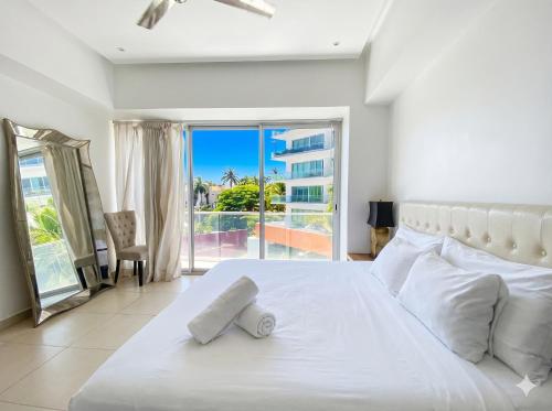 a bedroom with a large white bed and a balcony at ICON Oceanview Retreat by Monyxbnb in Puerto Vallarta
