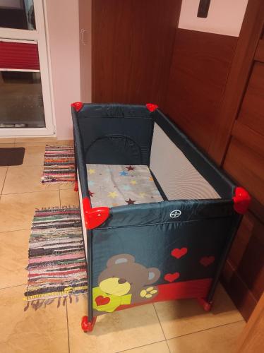 a toy crib with a mickey mouse on it at Pokoje Mirów1A in Mirów