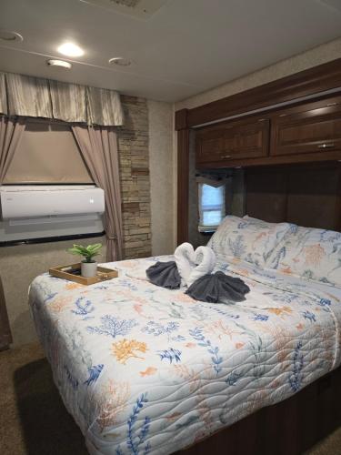 a bedroom with a bed with a towel animal on it at Tiki Cabana at Key Largo in Key Largo