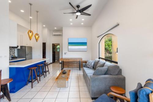 a living room with a couch and a table at Top-Floor Condo with Sweeping Ocean, Mountain & Marina Views in Playa Flamingo