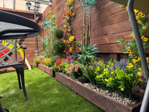 a garden with many different types of flowers at Blackpool cosy cottage in Blackpool