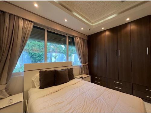 a bedroom with a large bed and a window at Mansión Versace in Panama City