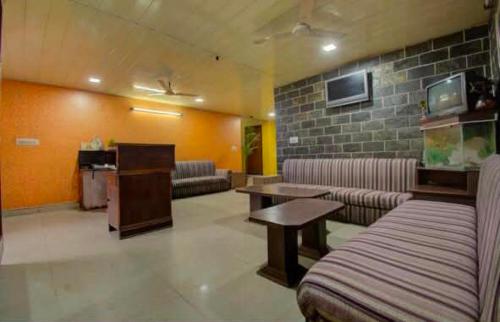 a lobby with couches and a table in a room at Hotel Shaan- M I Road City Centre in Jaipur