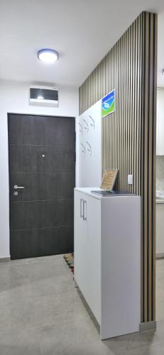 a room with a door and a counter with a laptop at Apartman Doboj in Doboj