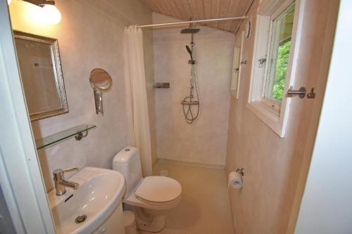 a small bathroom with a toilet and a sink at "Kiatorp" in Fagerhult
