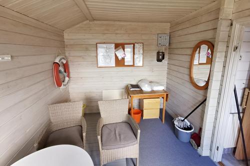 a small room with a desk and chairs in a tiny house at "Kiatorp" in Fagerhult