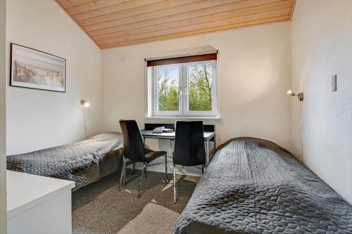 a bedroom with a desk and a bed and a window at C11331-Tarm-Brombaervej-5 in Tarm